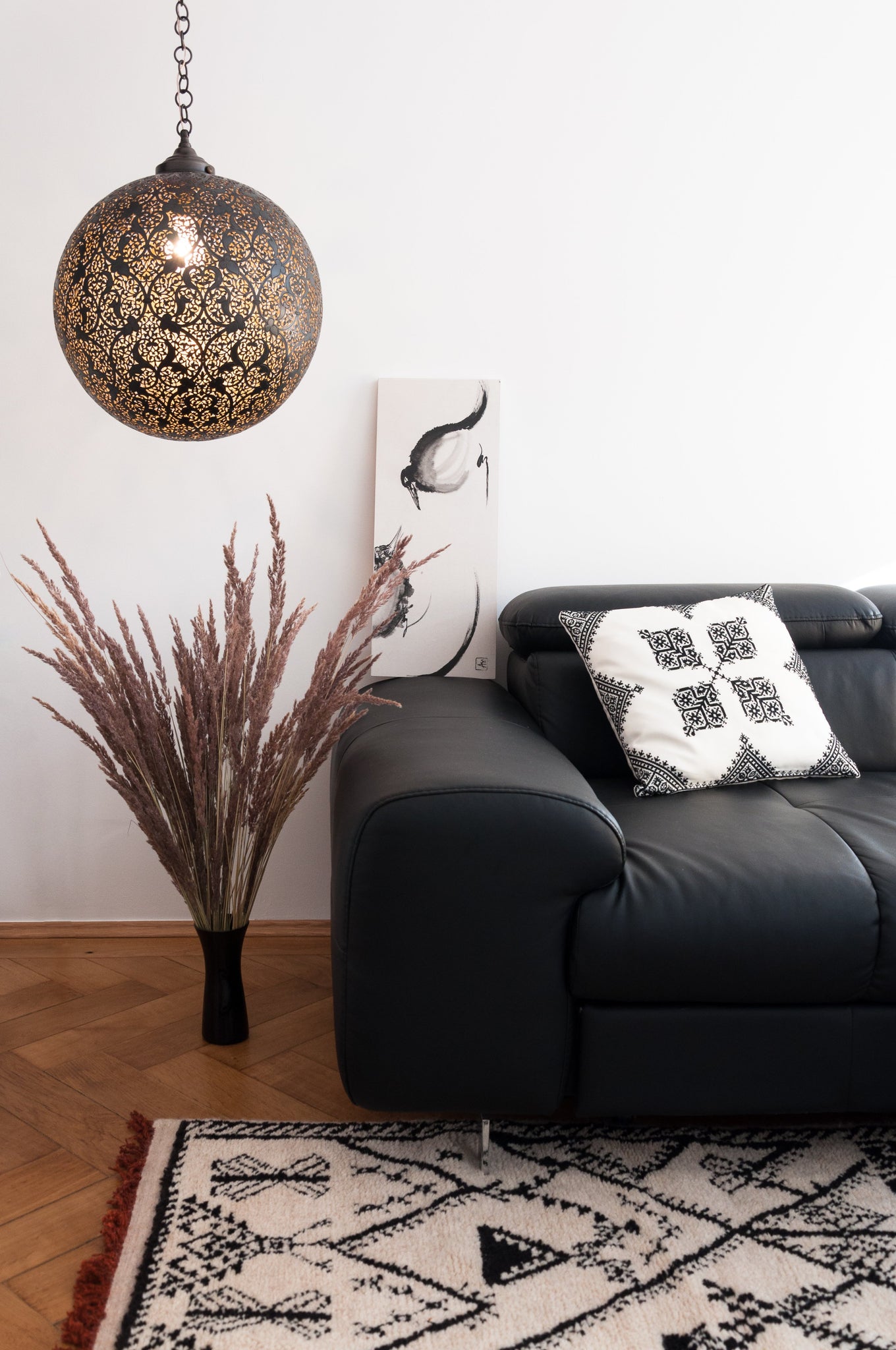 Moroccan handmade berber rug and brass hanging lamp in living room
